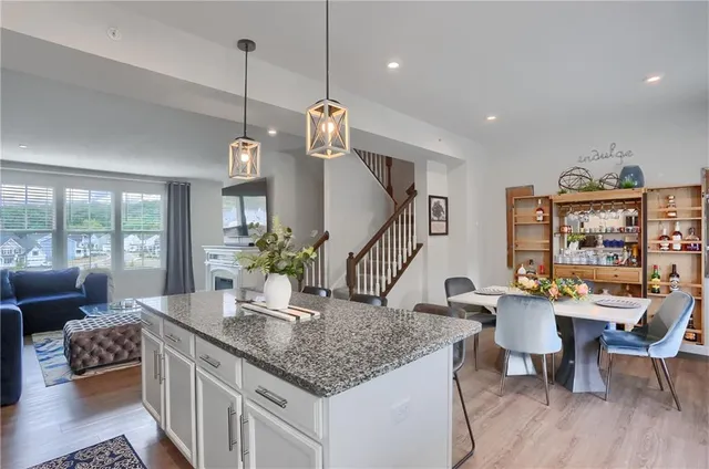 a dining room with furniture and wooden floor