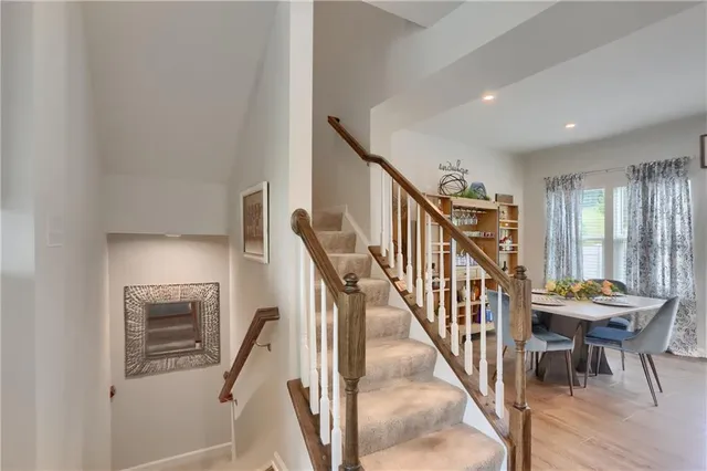 a livingroom with furniture wooden floor and a rug