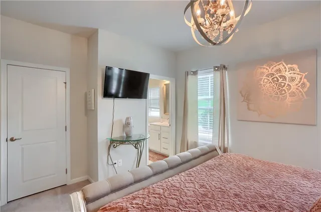 a bedroom with a bed and a television