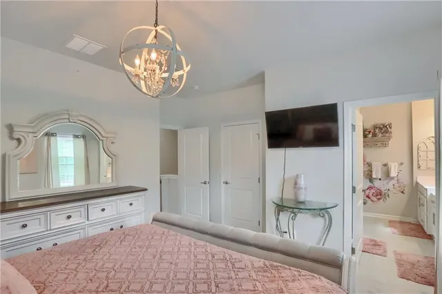 a view of a livingroom with wooden floor and a chandelier