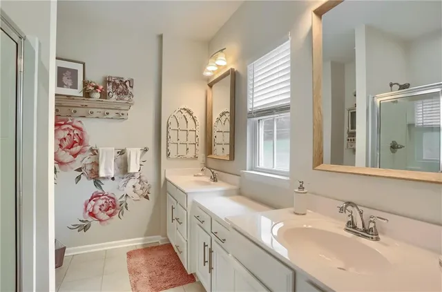 a bathroom with a sink mirror and a shower
