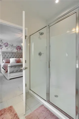 a bathroom with a shower and a glass door