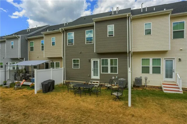 a backyard of a house with yard and barbeque oven