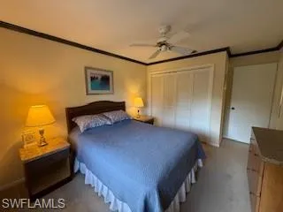 a bedroom with a bed and a lamp on the dresser