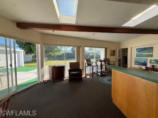 a living room with hardwood floor and a large window
