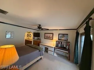 a bedroom with a bed and a wall painting