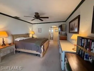 a bedroom with a bed couch and a window