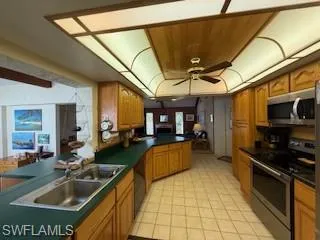 a kitchen with stainless steel appliances granite countertop a sink and cabinets