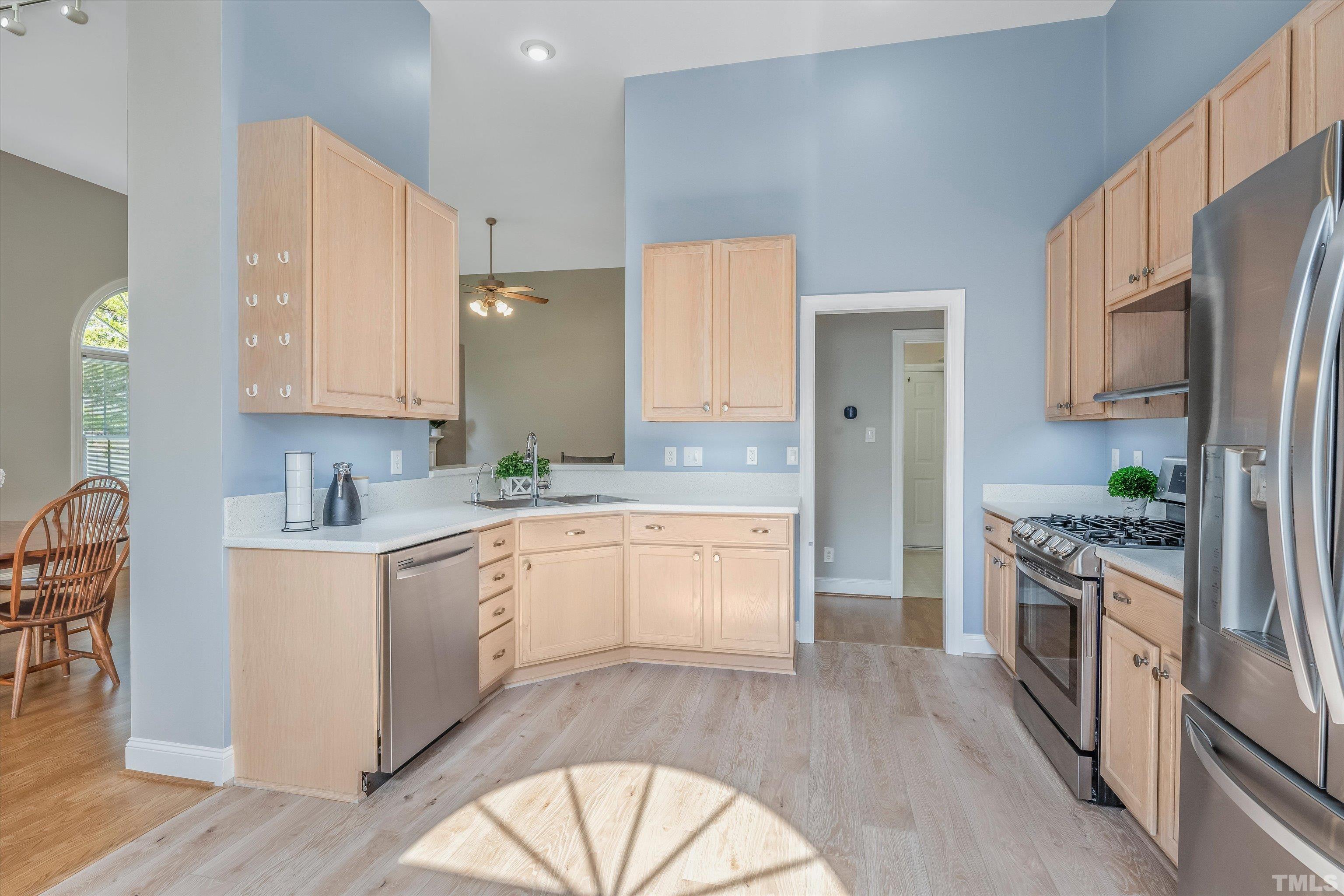 109 Rother Lane Durham, NC 27707 - Photo 11 of 25 a large kitchen with stainless steel appliances granite countertop a stove a sink and a refrigerator