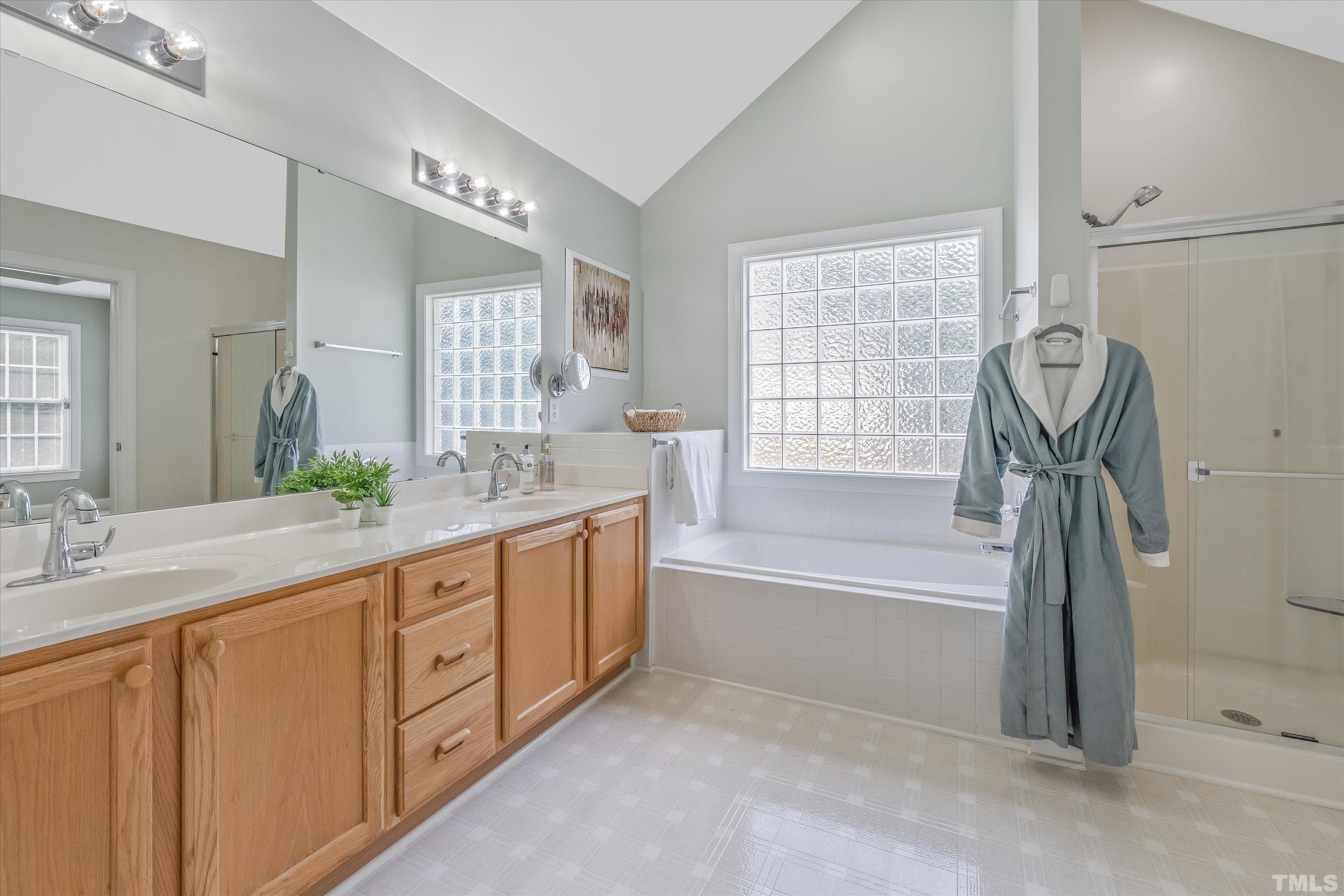 109 Rother Lane Durham, NC 27707 - Photo 15 of 25 a spacious bathroom with a tub sink shower and mirror