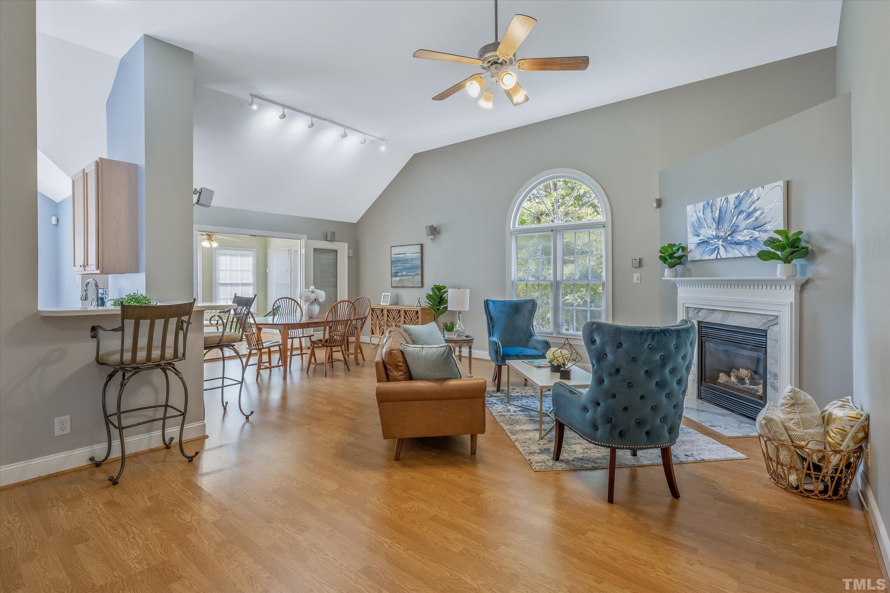 109 Rother Lane Durham, NC 27707 - Photo 2 of 25 a living room with furniture a fireplace and a chandelier