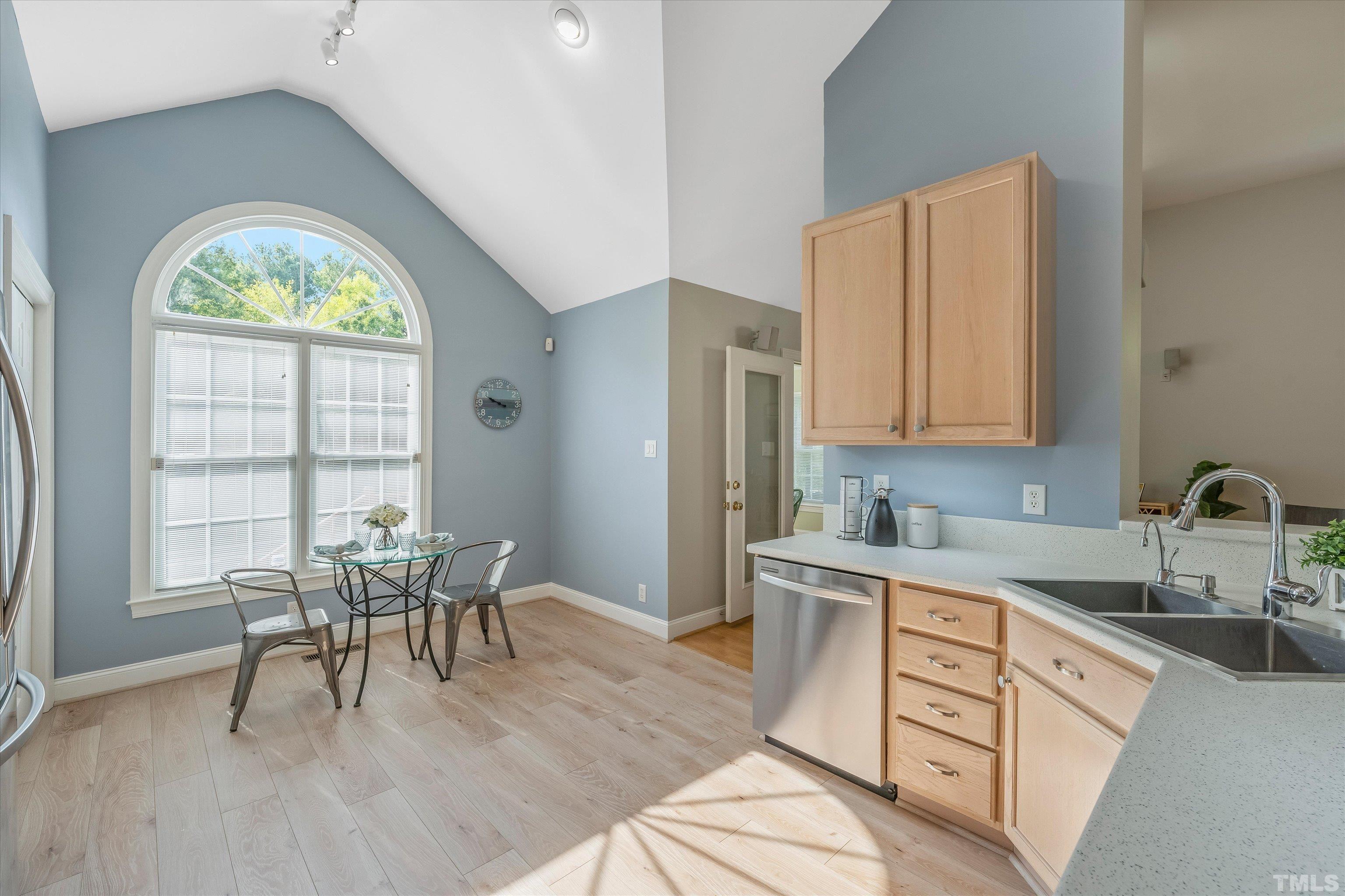 109 Rother Lane Durham, NC 27707 - Photo 9 of 25 a kitchen with stainless steel appliances granite countertop a stove a sink dishwasher a microwave oven and a dining table with wooden cabinet