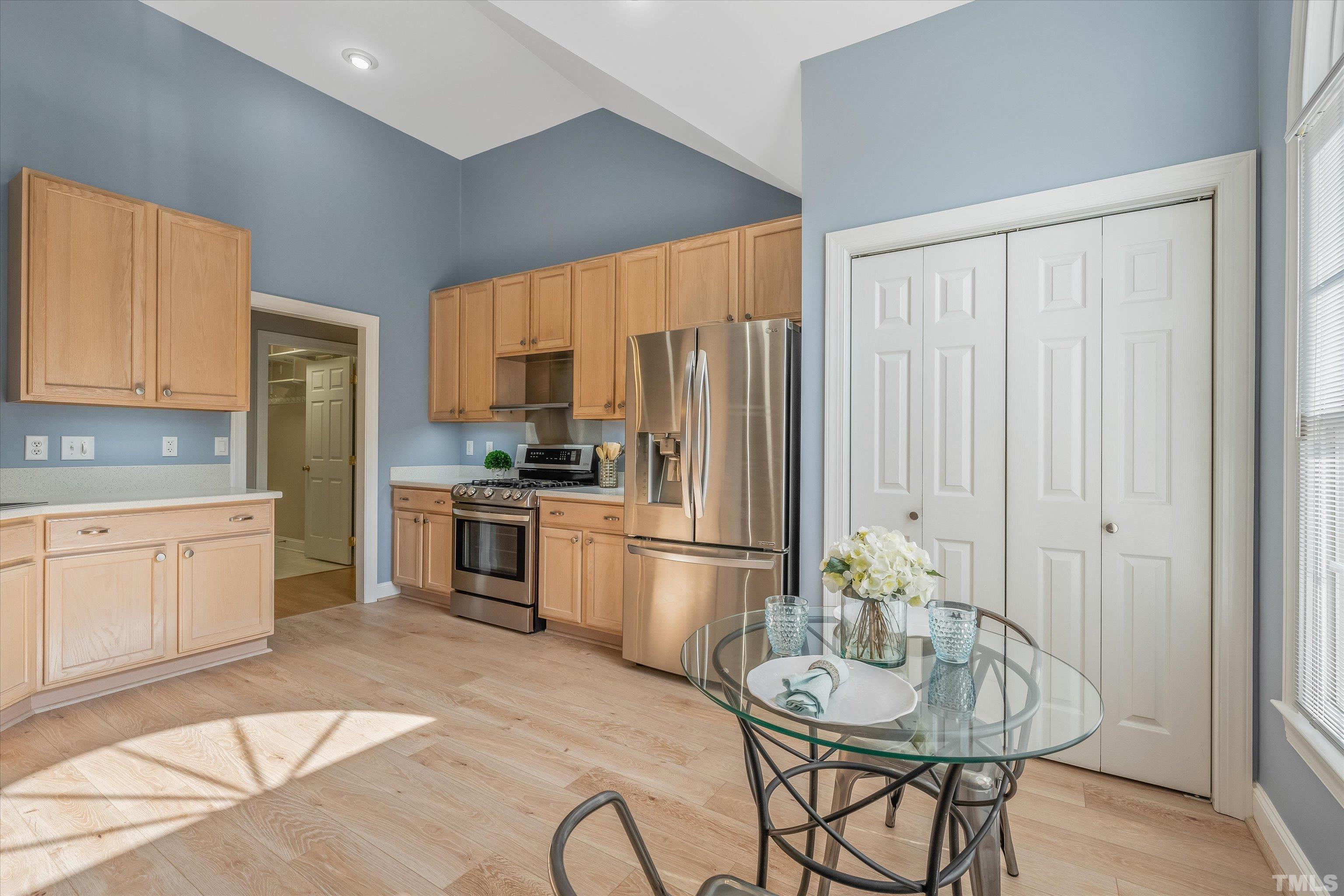 109 Rother Lane Durham, NC 27707 - Photo 10 of 25 a kitchen with granite countertop a refrigerator stove top oven dining table and chairs