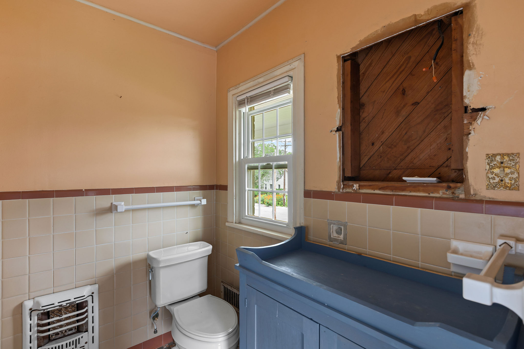 948 Maple Street Lockhart, TX 78644 - Photo 23 of 40 A well-lit bathroom, featuring a practical vanity and a classic toilet, promises comfort and utility.