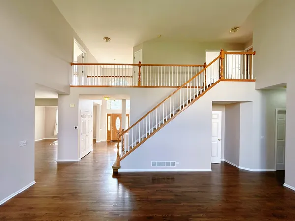 a view of entryway and hall with wooden floor