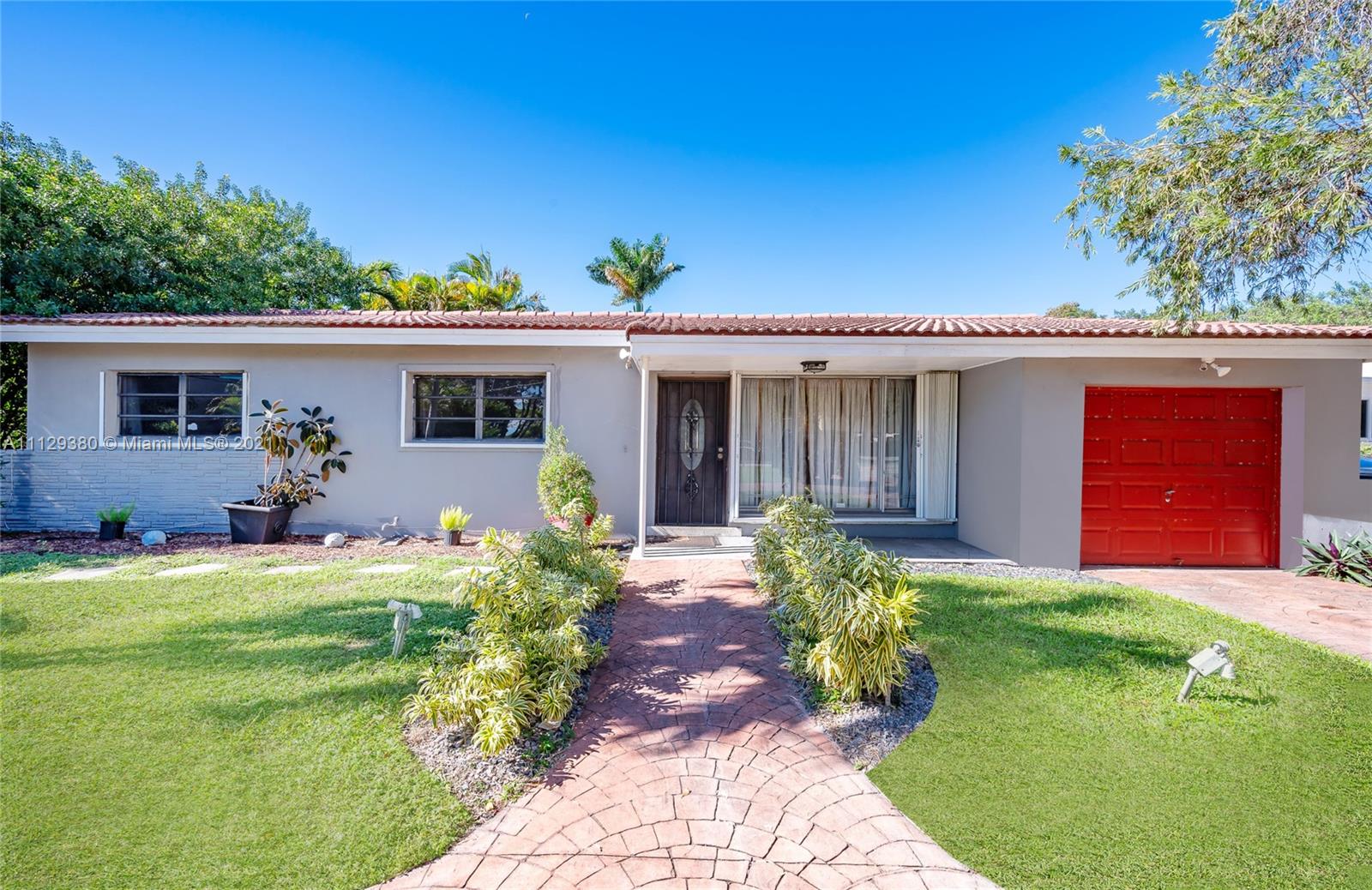12480 Griffing Boulevard North Miami, FL 33161 - Photo 1 of 31 a front view of house with yard and outdoor seating