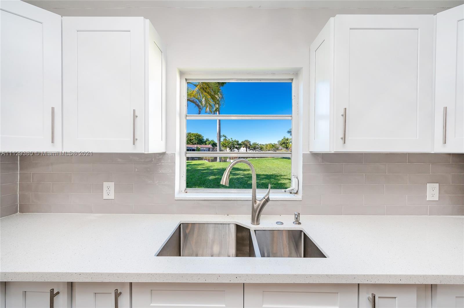 12480 Griffing Boulevard North Miami, FL 33161 - Photo 17 of 31 a kitchen with a sink and a window