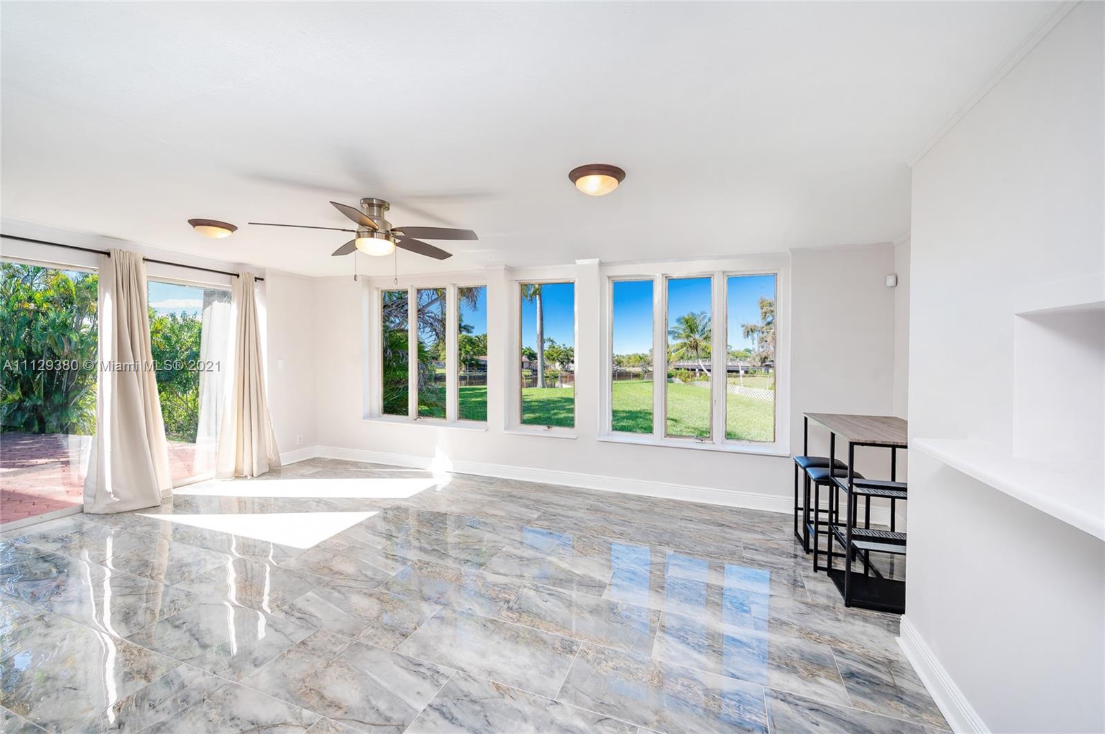 12480 Griffing Boulevard North Miami, FL 33161 - Photo 18 of 31 a view of an empty room with wooden floor and a window