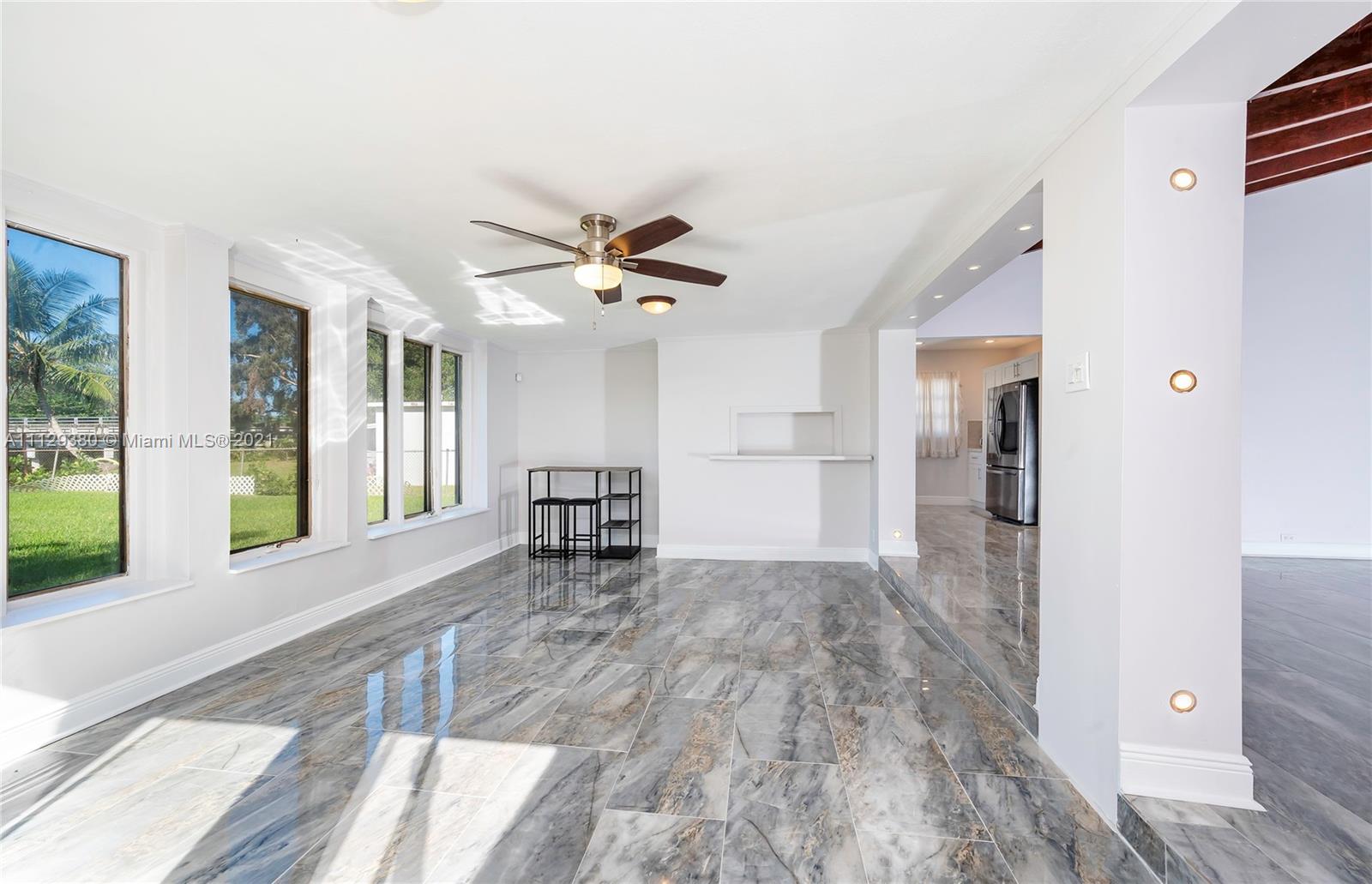 12480 Griffing Boulevard North Miami, FL 33161 - Photo 19 of 31 a view of a hallway with wooden floor and a window