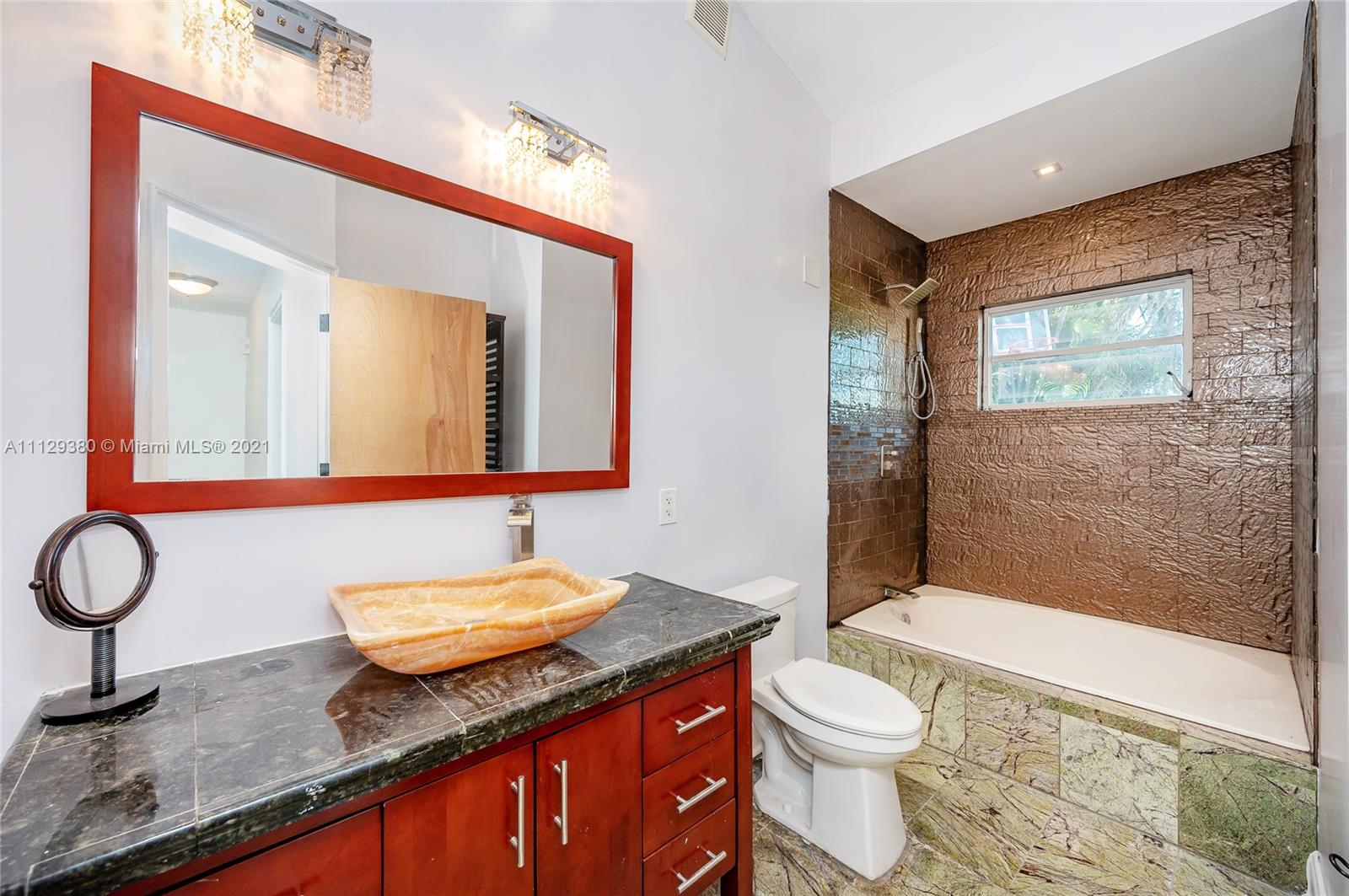 12480 Griffing Boulevard North Miami, FL 33161 - Photo 26 of 31 a bathroom with a granite countertop sink mirror vanity and toilet