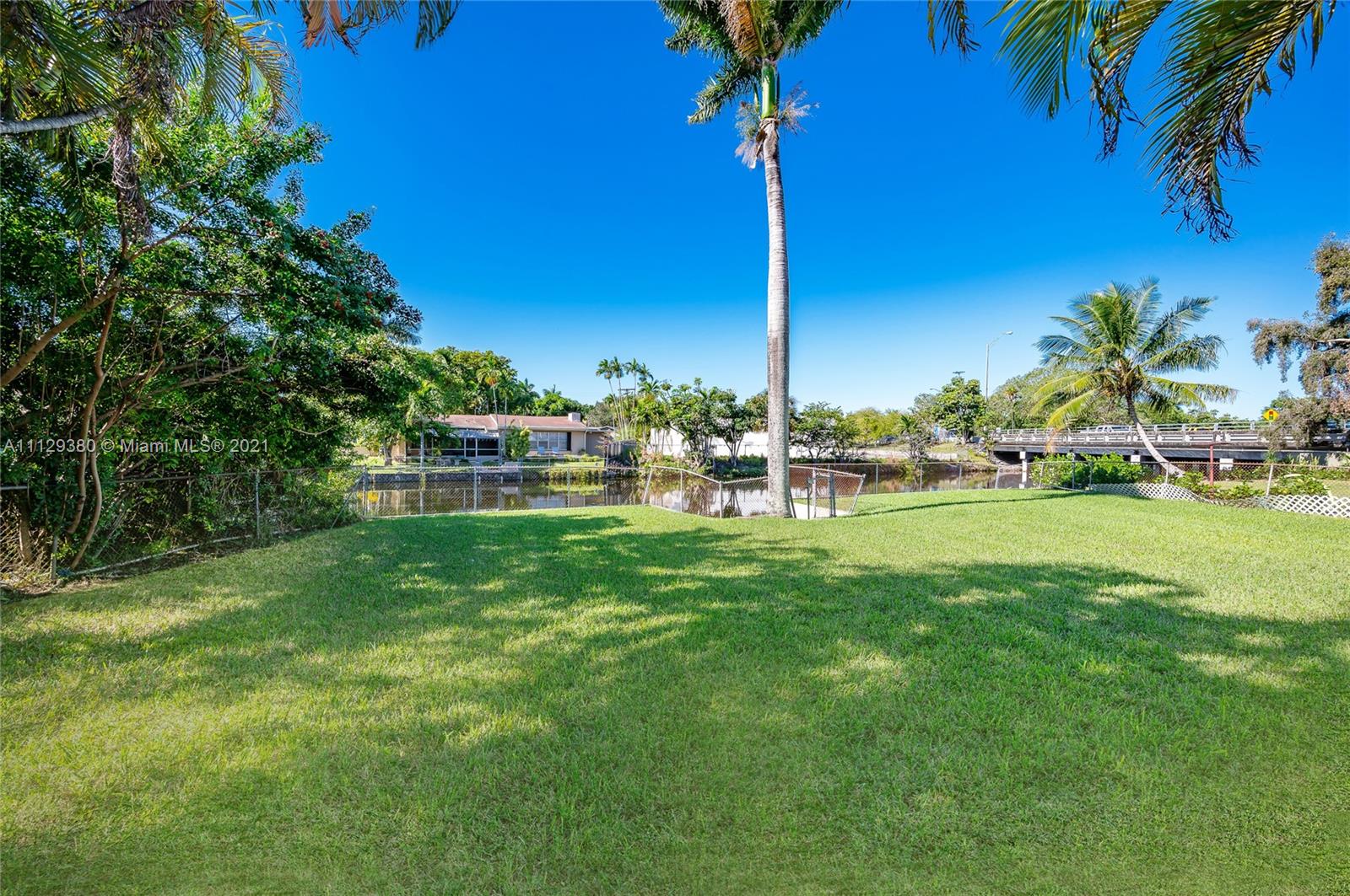 12480 Griffing Boulevard North Miami, FL 33161 - Photo 9 of 31 a view of a house with a big yard and palm trees