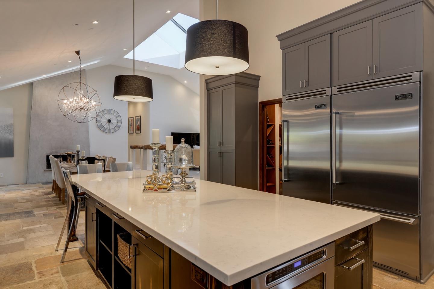 14480 Oak Place Saratoga, CA 95070 - Photo 11 of 45 a kitchen with stainless steel appliances a table chairs and a refrigerator