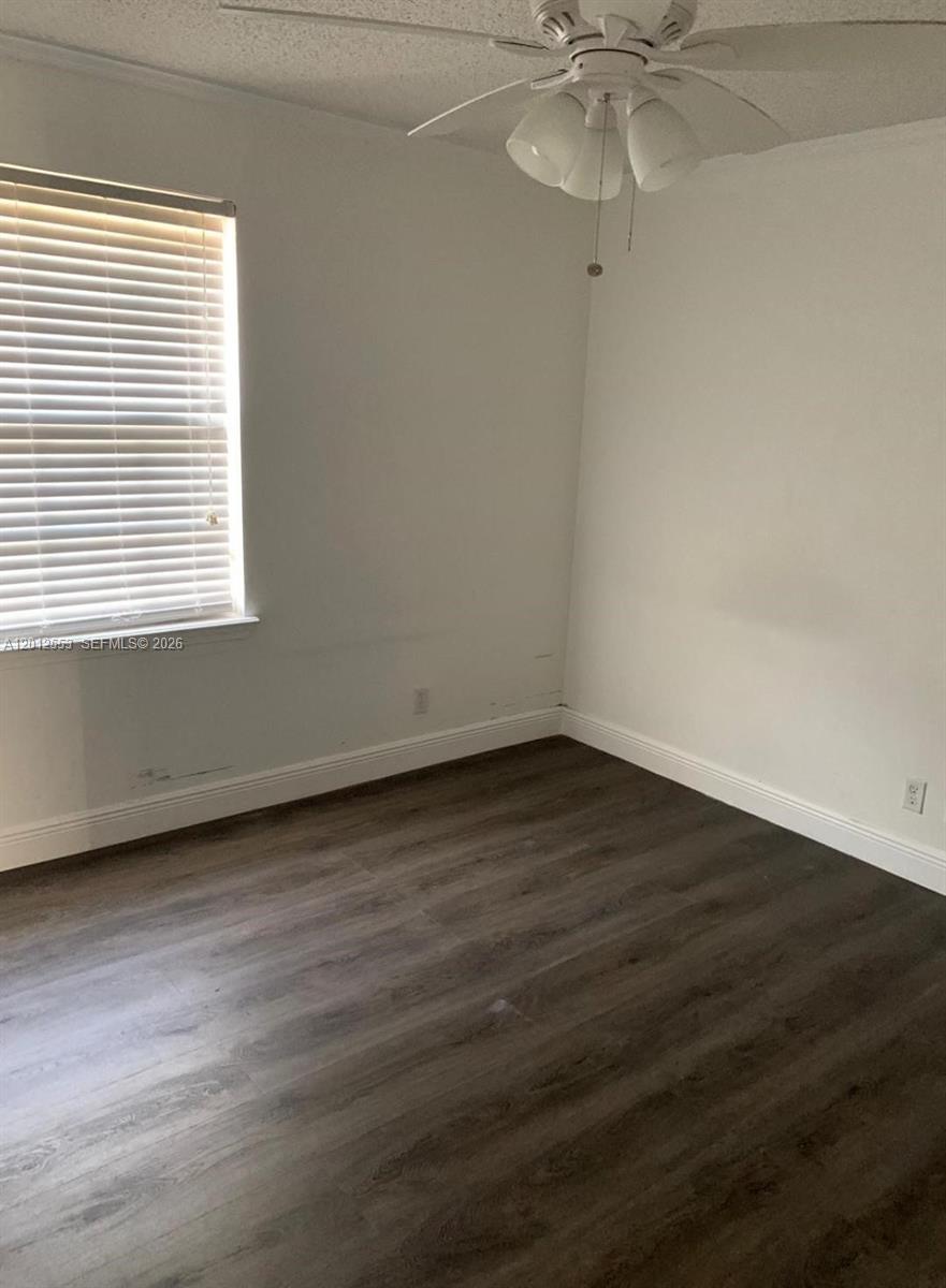 6975 Blacksmith Way Lake Worth, FL 33467 - Photo 13 of 21 an empty room with wooden floor and windows