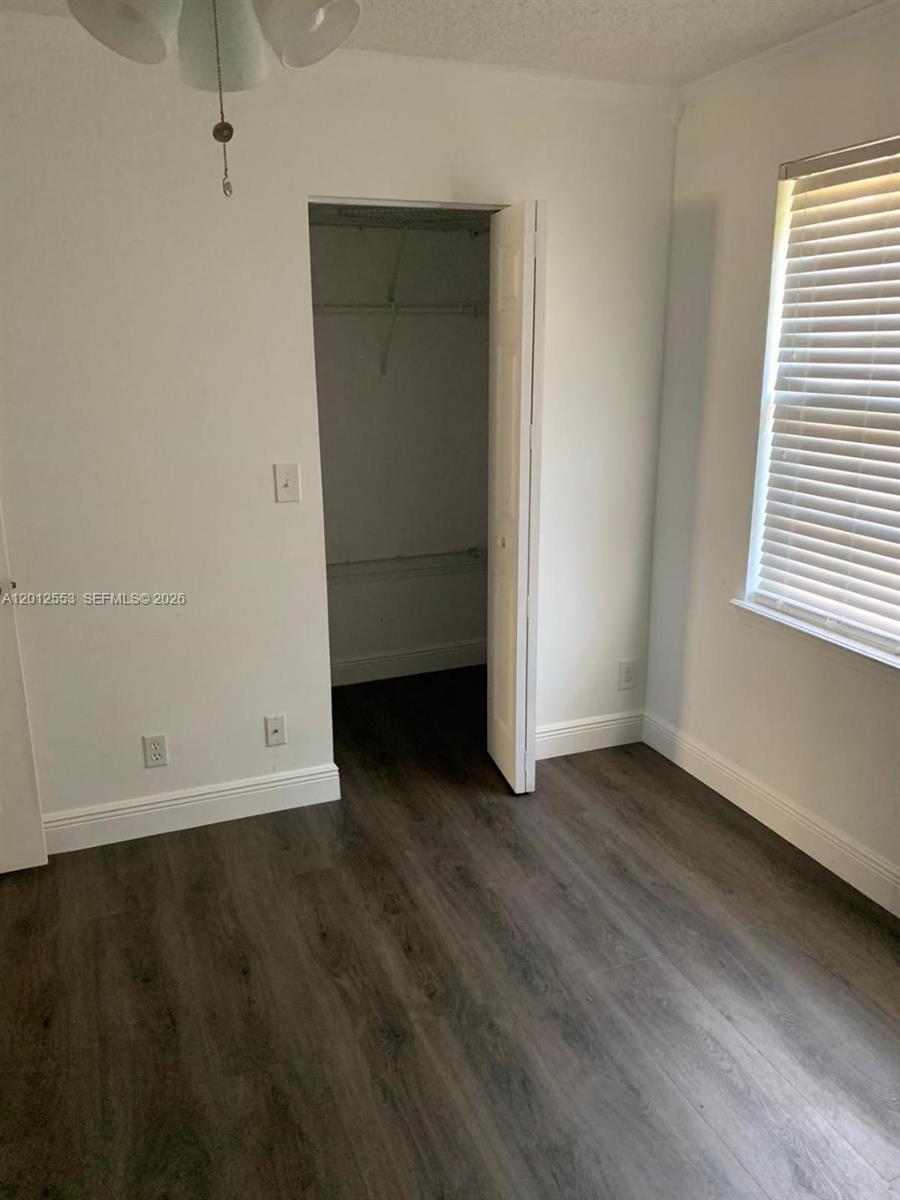 6975 Blacksmith Way Lake Worth, FL 33467 - Photo 14 of 21 an empty room with wooden floor and windows