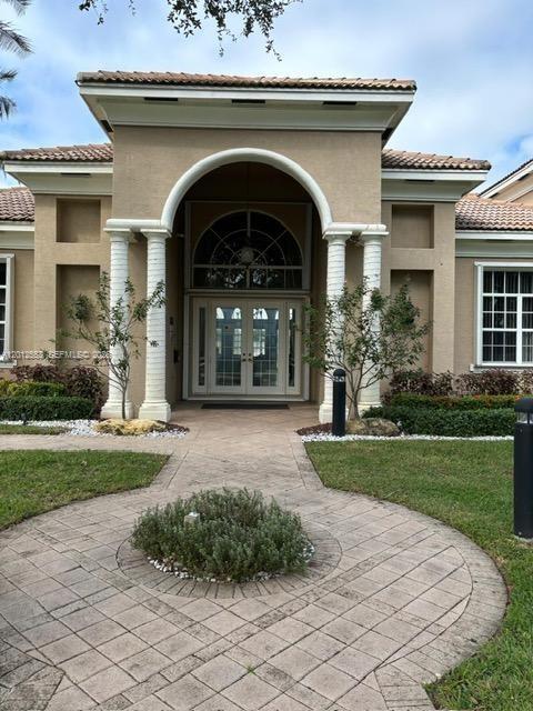 6975 Blacksmith Way Lake Worth, FL 33467 - Photo 16 of 21 a front view of a house with garden