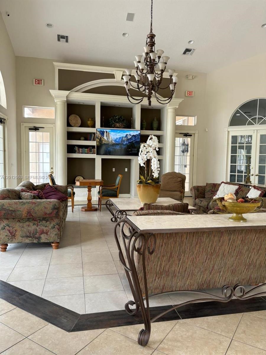 6975 Blacksmith Way Lake Worth, FL 33467 - Photo 18 of 21 a living room with fireplace furniture and a chandelier