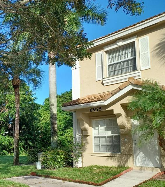 6975 Blacksmith Way Lake Worth, FL 33467 - Photo 2 of 21 a front view of a house with a yard