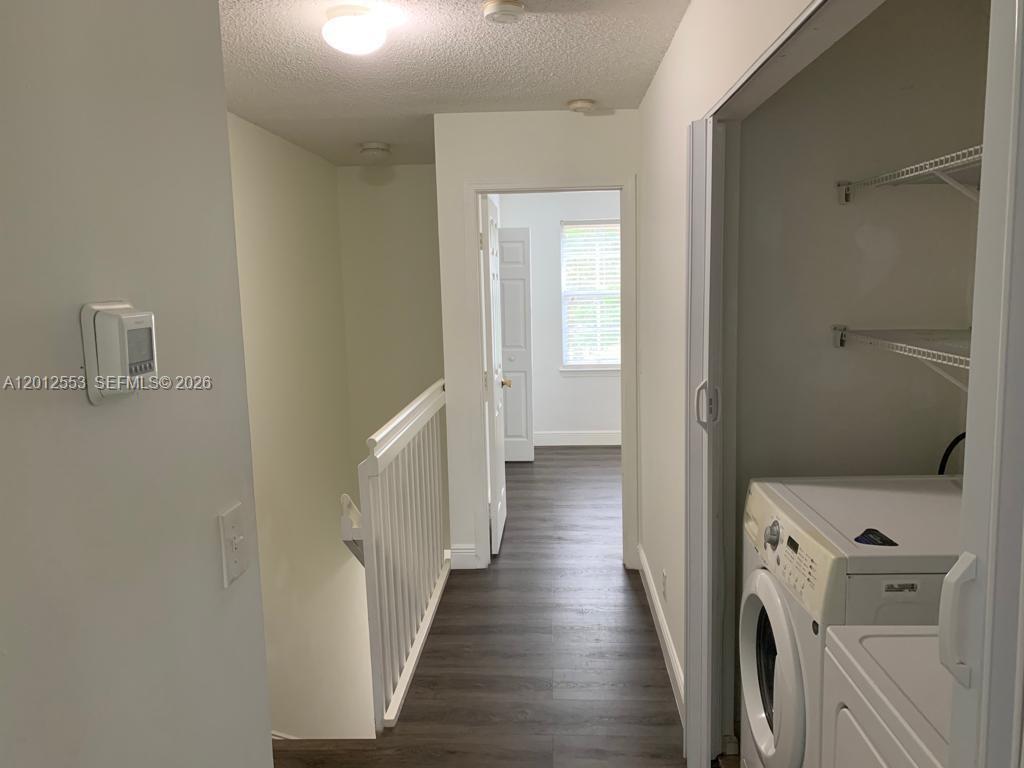 6975 Blacksmith Way Lake Worth, FL 33467 - Photo 9 of 21 a view of a hallway with wooden floor and a bathroom