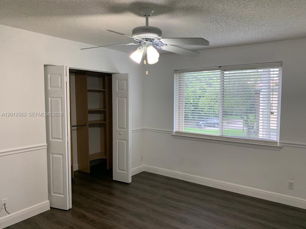 6975 Blacksmith Way Lake Worth, FL 33467 - Photo 10 of 21 a view of an empty room with wooden floor and a window