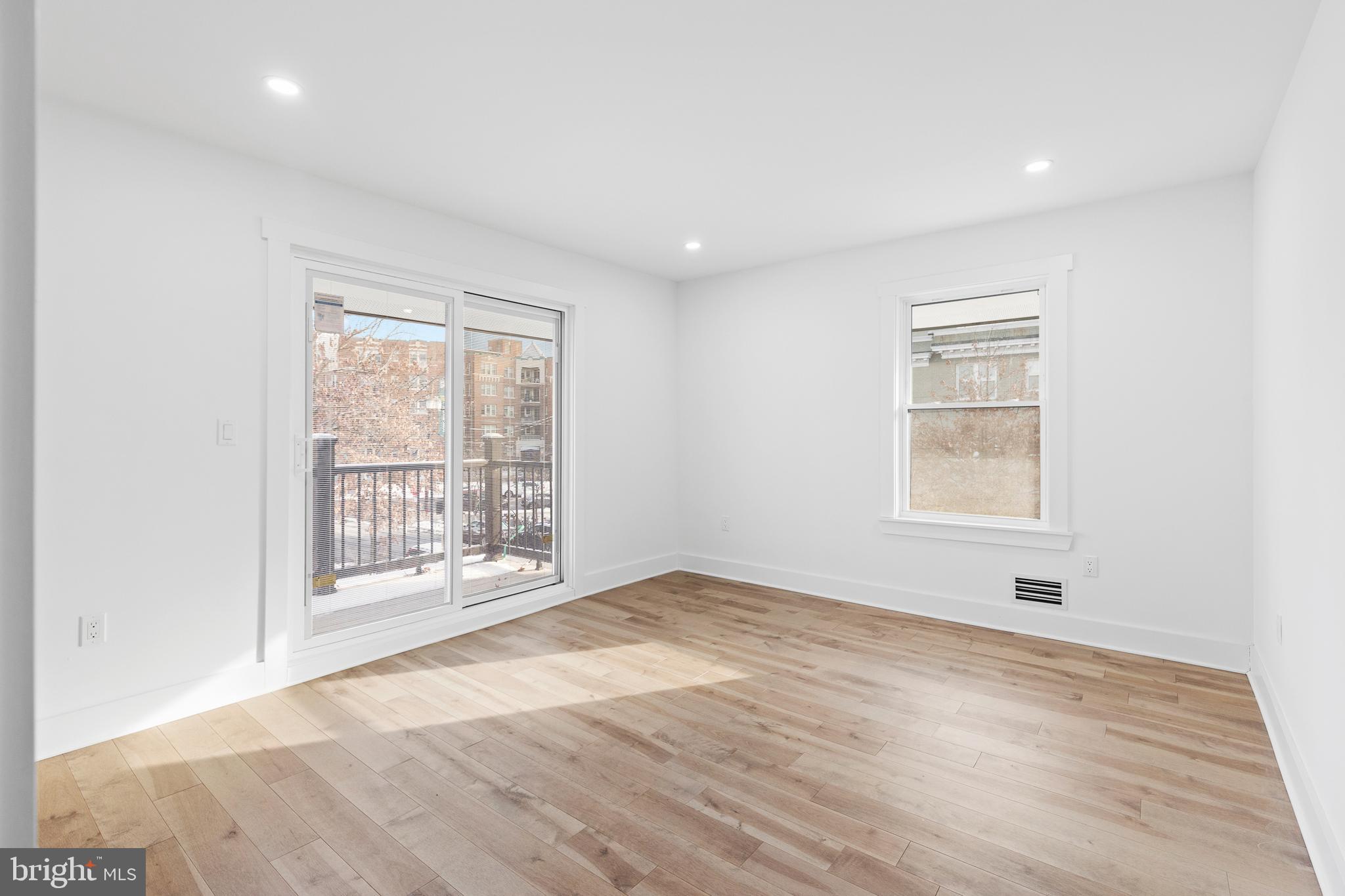 1355 Longfellow Street Northwest Washington, DC 20011 - Photo 24 of 37 an empty room with wooden floor and windows