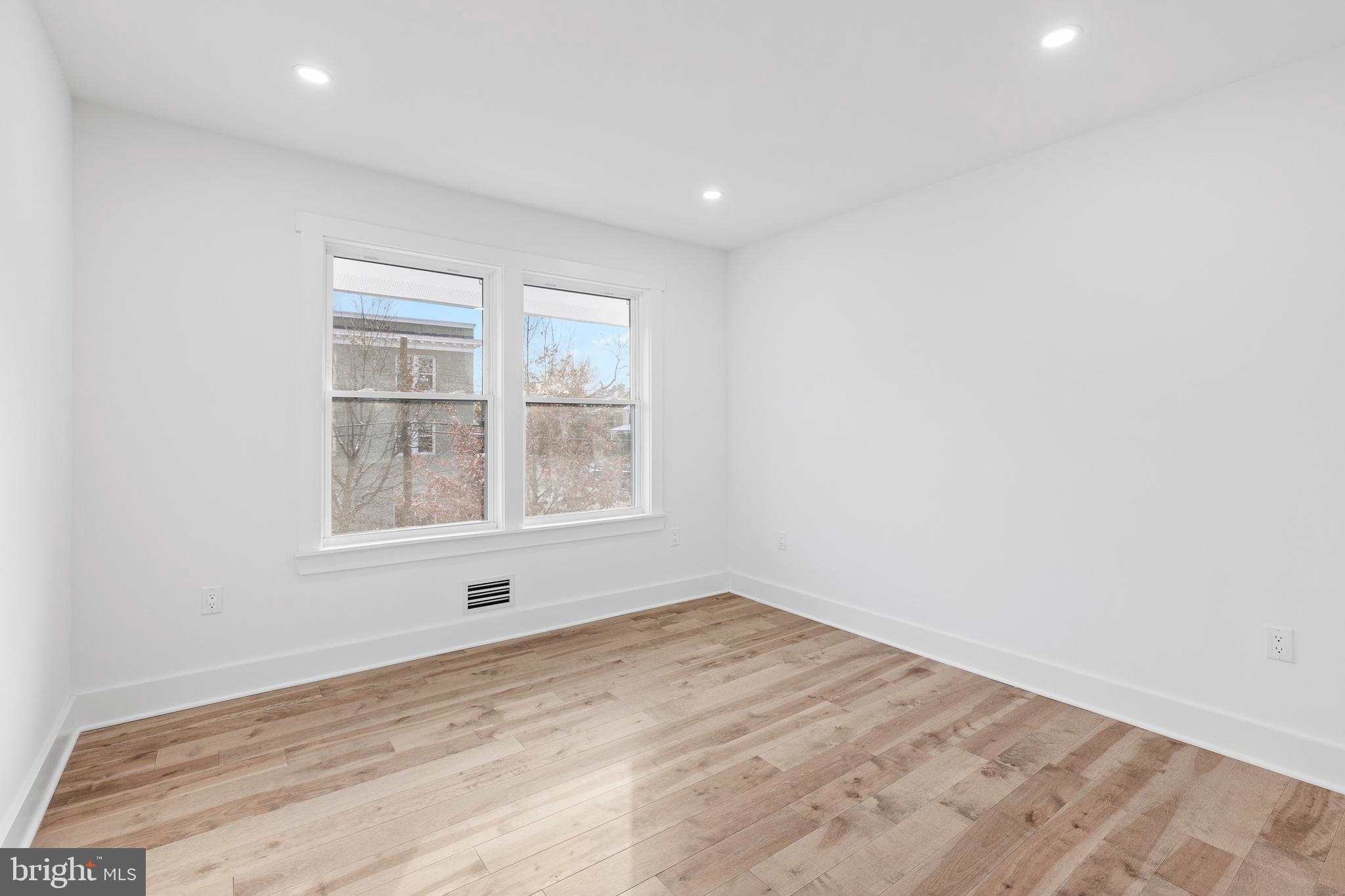 1355 Longfellow Street Northwest Washington, DC 20011 - Photo 27 of 37 an empty room with wooden floor and windows