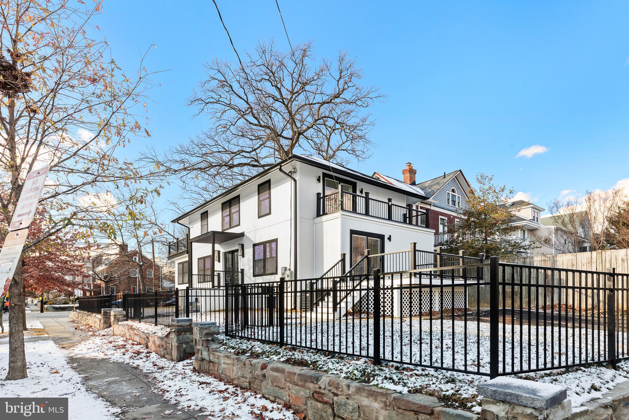 1355 Longfellow Street Northwest Washington, DC 20011 - Photo 4 of 37 a view of a white house with a large window and wooden fence