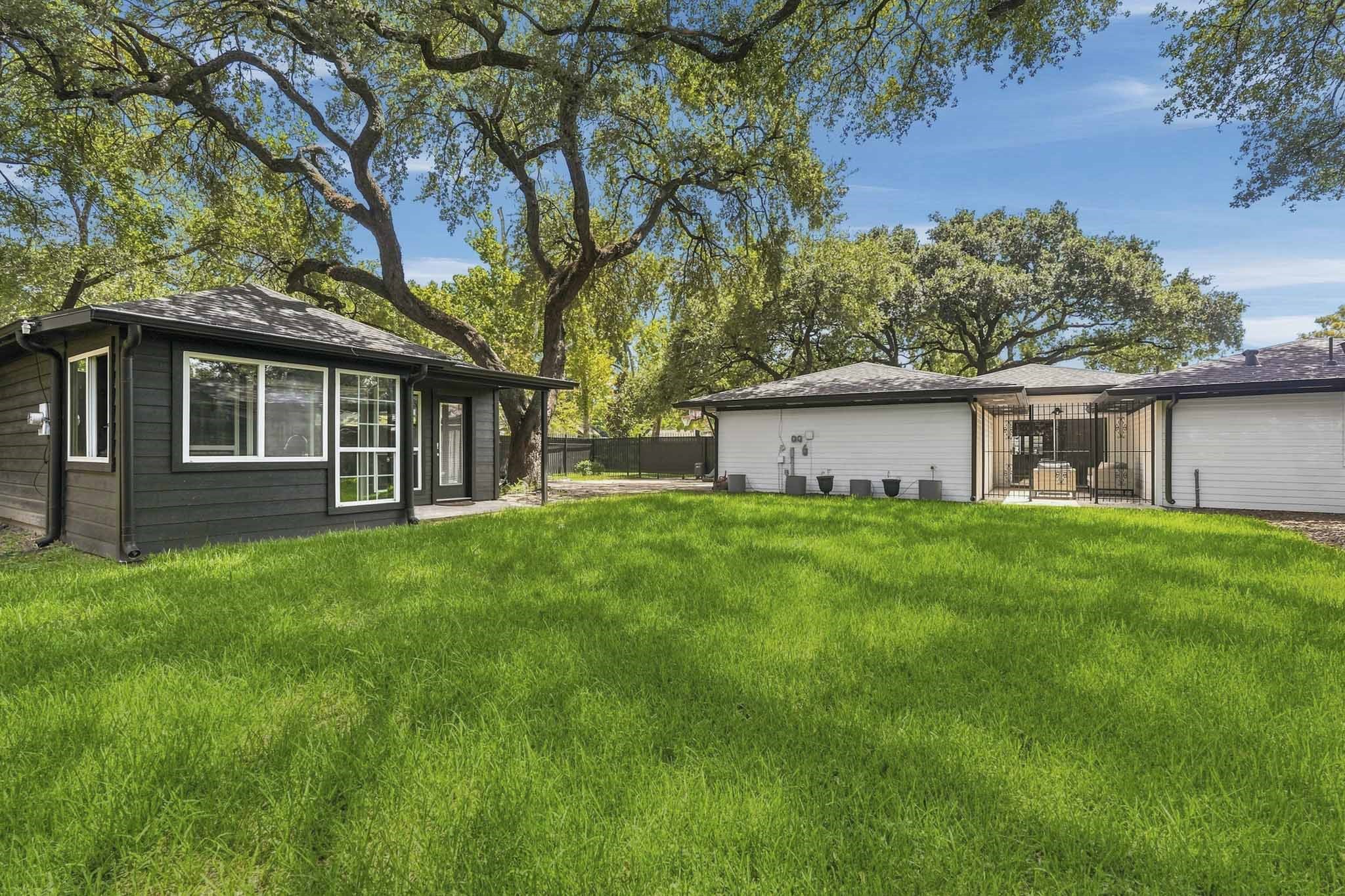 2302 Chimney Rock Road Houston, TX 77056 - Photo 24 of 28 Large backyard offering plenty of space should you decide to build a pool. Large live oaks provide plenty of shade, 10 Magnolia trees recently planted in the backyard to provide privacy as they mature. Spacious storage shed to store extra things or convert it into a "she" shed or man-cave. Backyard also features soffit accent lighting around the home, exterior flood lighting, new cedar privacy fence, full sprinkler system, complete gutter system, backyard drainage system and an outdoor kitchen.