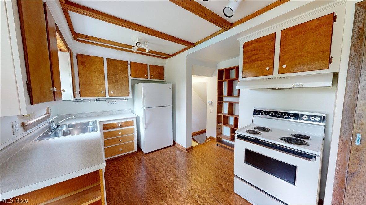 1508 Edgefield Road Lyndhurst, OH 44124 - Photo 8 of 28 Kitchen featuring white appliances, wood-style flooring, and sink