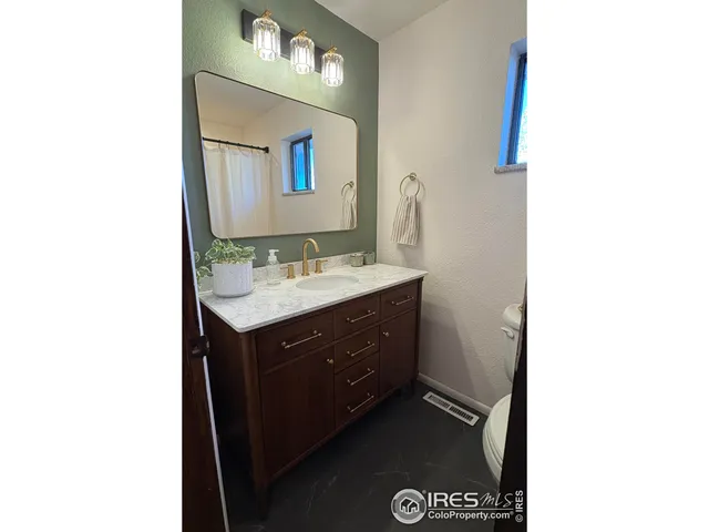 a bathroom with a sink vanity and mirror
