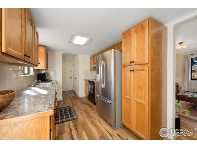 a kitchen with stainless steel appliances granite countertop a refrigerator and a sink