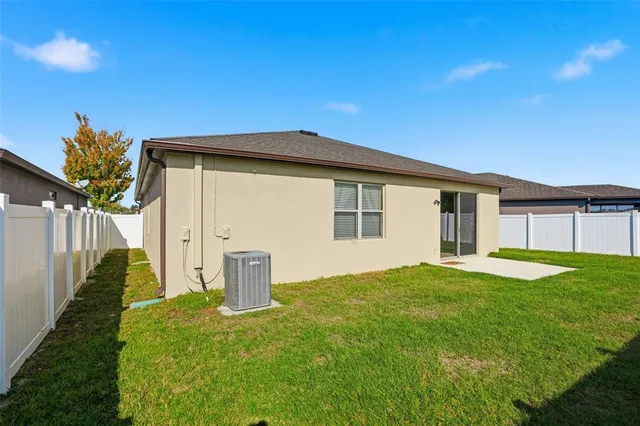 a backyard of a house with table and chairs