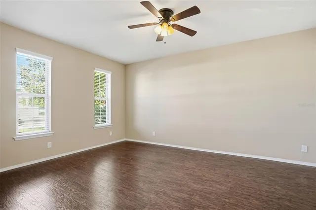 a view of a room with wooden floor and a window