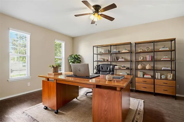 a view of a workspace with furniture and a window