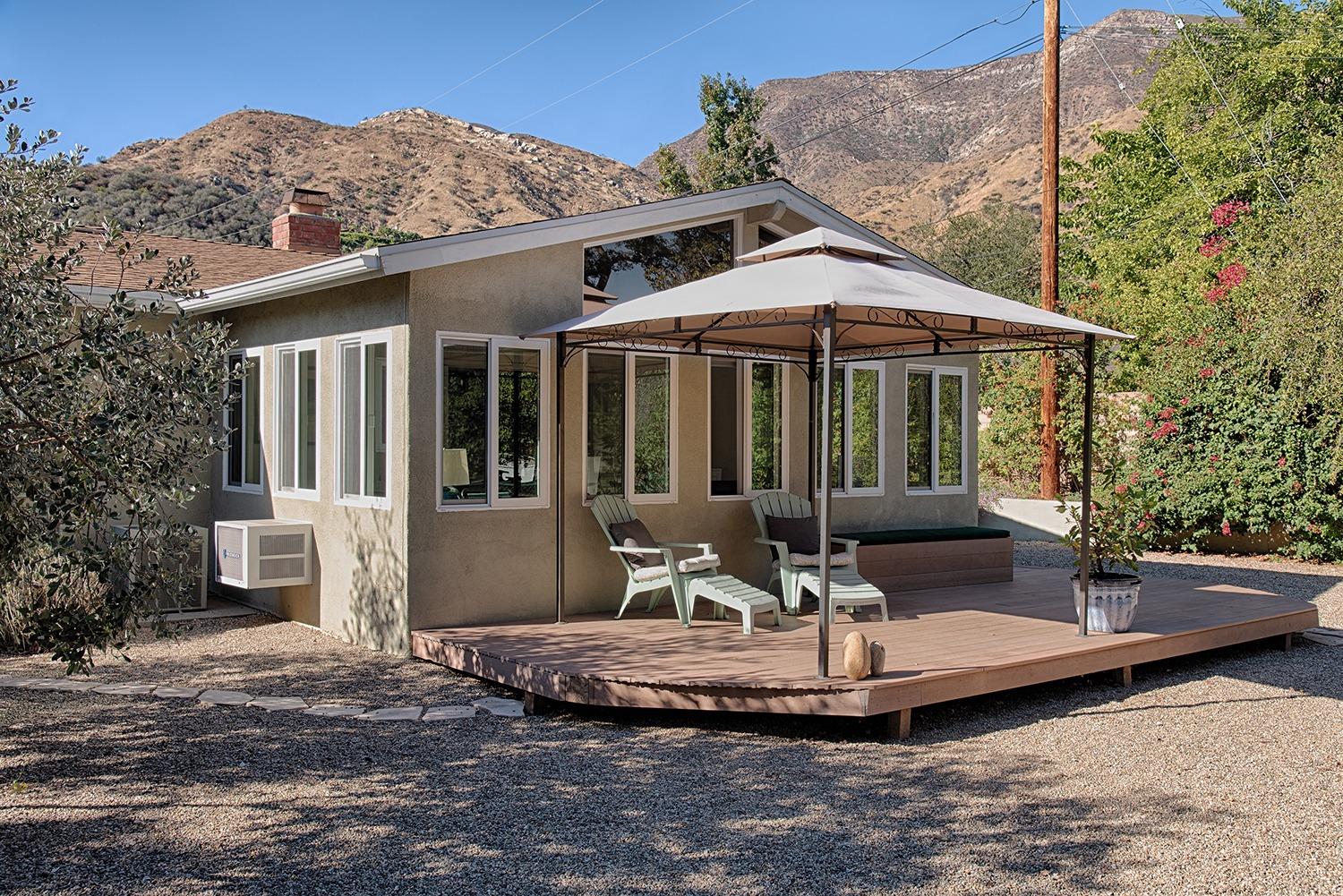 1310 Daly Road Ojai, CA 93023 - Photo 15 of 18 a view of a house with backyard fountain and a fire pit