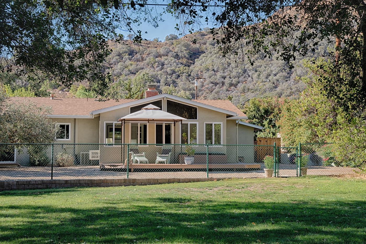 1310 Daly Road Ojai, CA 93023 - Photo 17 of 18 a front view of a house with a yard patio and fire pit