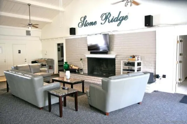 a view of swimming pool with a yard from a tub