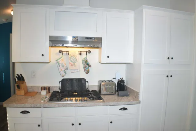 a room with a mirror and cabinets