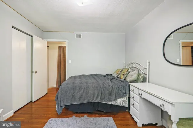 a bedroom with a bed and a mirror