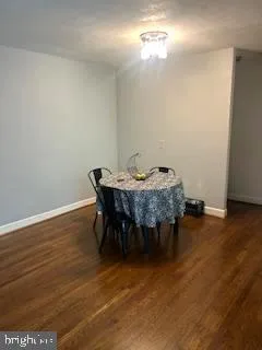 a view of a room with furniture and wooden floor