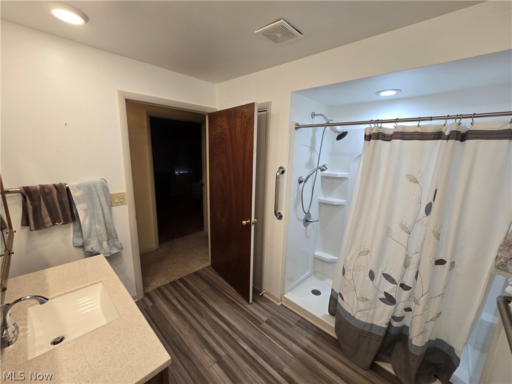 2550 Merria Road Stow, OH 44224 - Photo 15 of 22 Bathroom with curtained shower, sink, and wood-type flooring